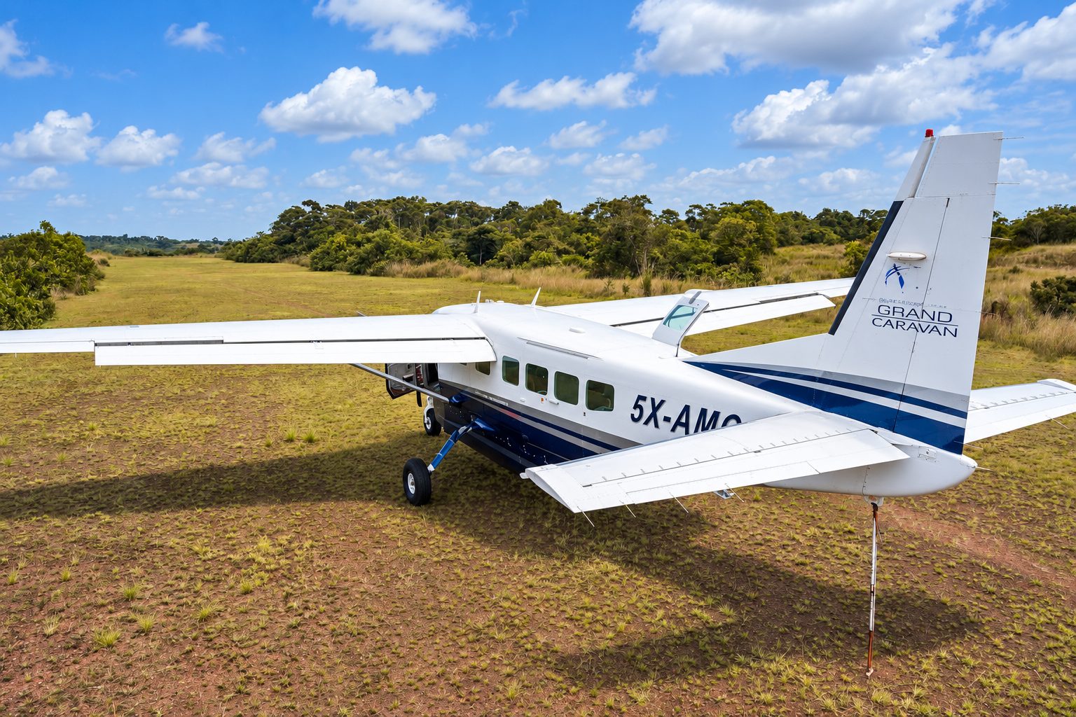 Asante Aviation Grand Caravan on a green airstrip in Uganda