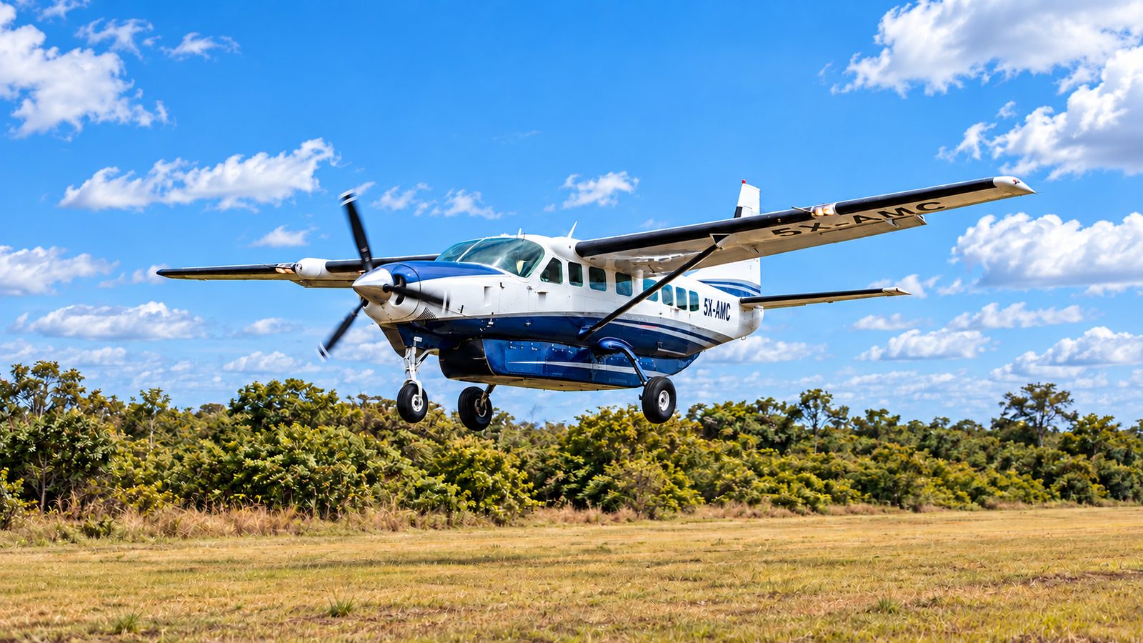 Asante Aviation Cessna Grand Caravan 5X-AMC on final approach to a grass airstrip in Uganda